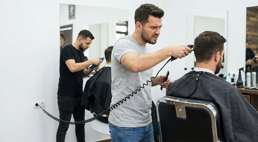 barber frustrated using corded clipper